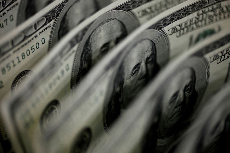 Dollar edges higher, buoyed by monetary policy imbalance